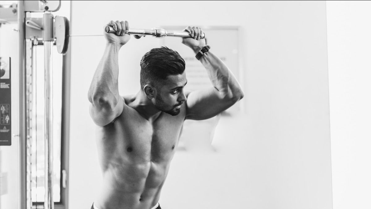 grayscale photo of man in gym